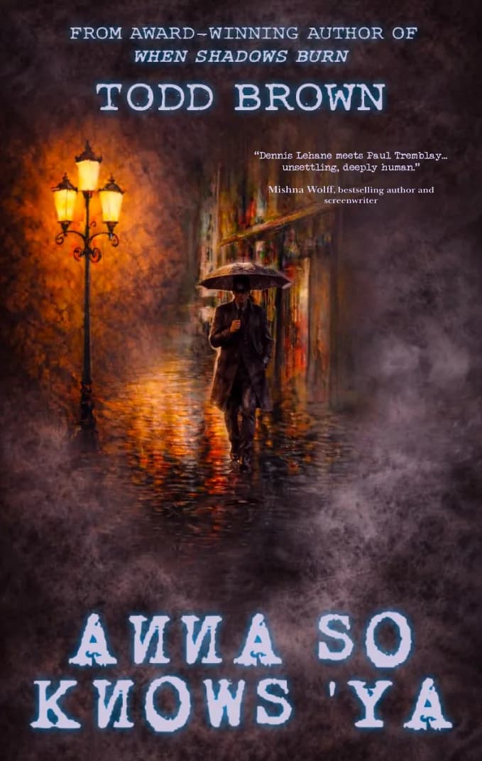 A man walking on a dimly lit street holding an umbrella