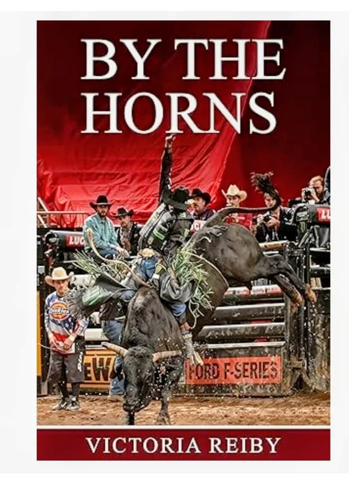 A young man is riding a bucking bull in a rodeo arena. The stands are packed full of cheering people. The dust billows behind the bull and rider.