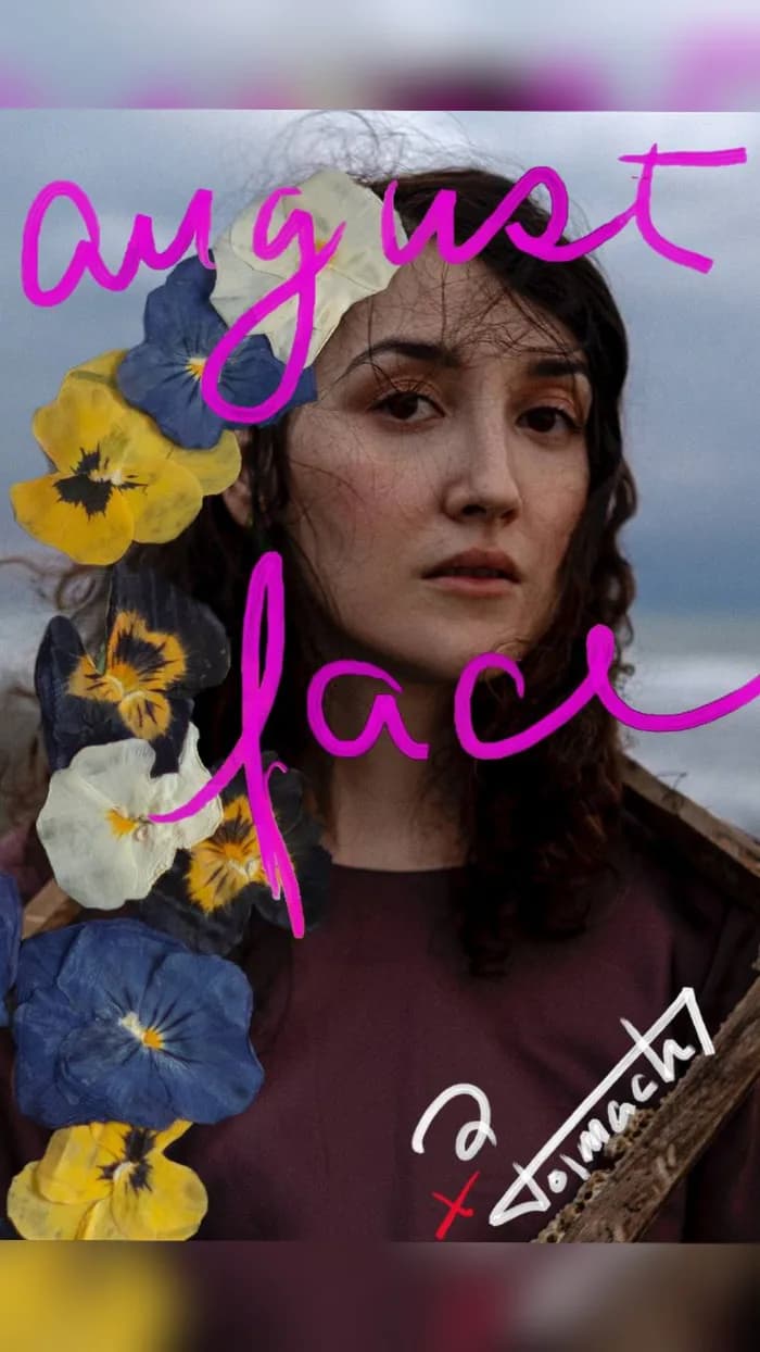 A woman's face, with flowers and the hand-painted title August Face, and author's signature, fantasy, romantic, greek myths, espionage, scifi